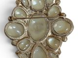 an image of a broochle with white stones on a white background
