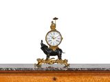 a clock on top of a table with a statue of a horse