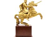 statue of a man on a horse with a sword on a wooden base