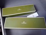 pair of green boxes with white writing on them sitting in a box