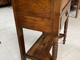 a small wooden table with a book on top of it