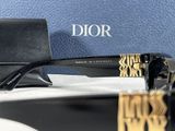 a pair of sunglasses sitting on a table next to a purse