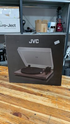 an open box of a record player sitting on top of a wooden table