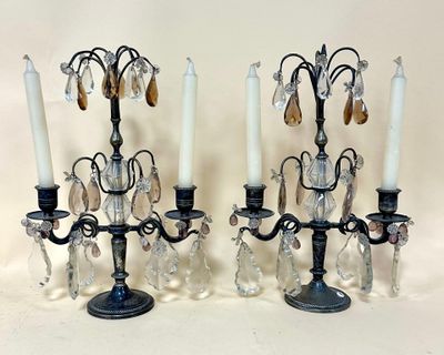 pair of antique black candelabs with crystal drops and candles