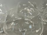 several empty wine glasses are lined up on a table