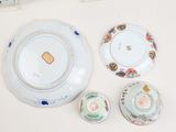 three plates and a bowl sitting on a table