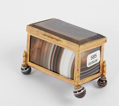 a small wooden box with marbles on wheels