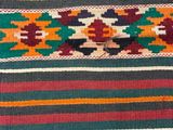 a close up of a colorful rug with a pattern on it