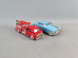two toy cars sitting next to each other on a table