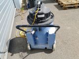 a machine that is sitting on the ground next to a building