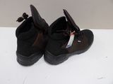 pair of black hiking boots on a white surface with a tag on it
