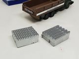 a toy truck that is sitting on a table next to a box