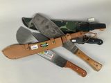 three different types of knives with leather sheaths on a white surface