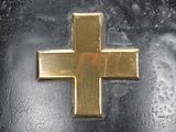 a close up of a helmet with a cross on it