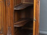 a wooden cabinet that has a shelf on top of it