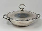 an antique silver plated casserole with a lid and handles