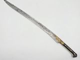 an old knife with a gold handle on a white surface