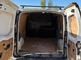 a white van with its door open in the dirt