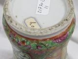 a vase with a floral design on it sitting on a white surface