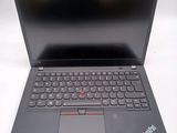the laptop is open on a white surface with a black keyboard