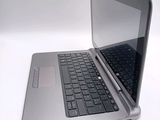 a silver laptop with a black keyboard on a white surface
