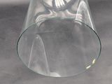 a glass vase with a clock inside of it on a table