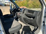 the interior of a van with the door open and the driver ' s seat down