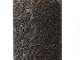 a black and gold vase with a gold top on a white background