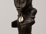 wooden figurine of a man with a hat on his head