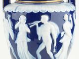a blue vase with a gold handle on a white background