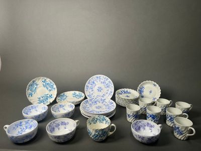 a lot of blue and white dishes and cups on the table