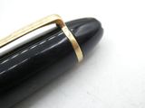 a close up of a pen with a gold band on it