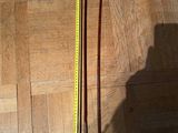 a picture of a pair of skis and a measuring tape on a wooden floor