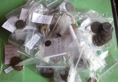 a pile of coins in a plastic bag on a table