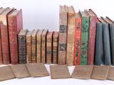 many old books that are stacked on top of each other