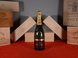a bottle of wine sitting on a table next to wooden boxes