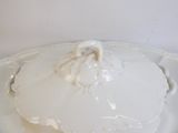 a white plate topped with a white frosting covered dish