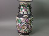 a vase with a floral design on it sitting on a table