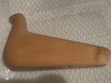 a small wooden object on a white surface