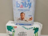 a baby diaper sitting on top of a box of toilet paper