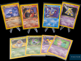 Plusieurs cartes Pokémon sont alignées les unes à côté des autres sur un fond noir.