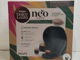 the box of coffee is open on a white surface