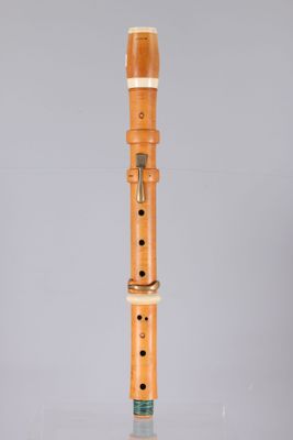 an image of a flute with a wooden body on a grey background