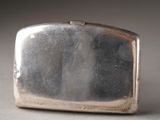 a silver purse that is sitting on a table