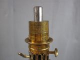 a gold colored lamp that is on top of a table