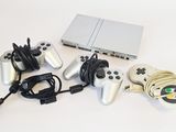 a lot of game controllers and a laptop on the table