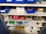many bins of items on the shelves in the store