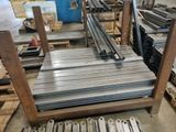 several pieces of metal are stacked on a pallet in a warehouse