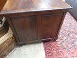 a small wooden cabinet with a door on top of it