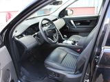 the interior of a car with the door open and the driver ' s seat down